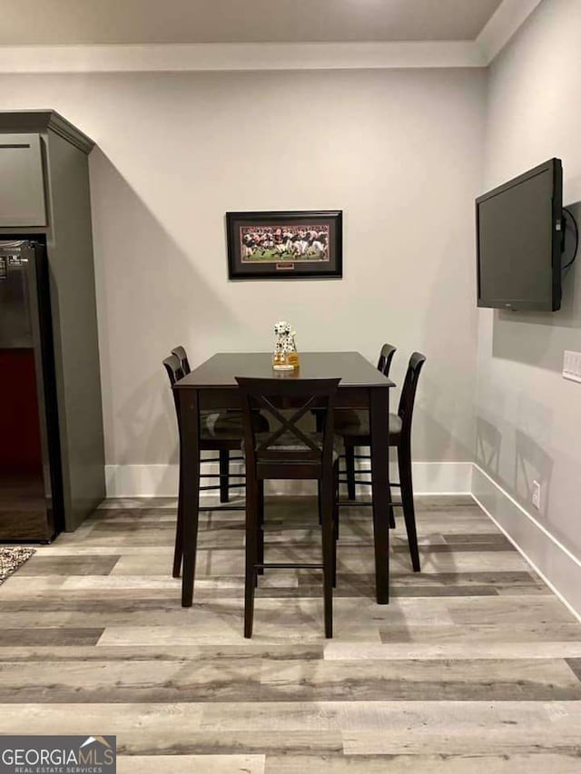 4821 Deer Creek Ct, Flowery Branch, GA 30542 - dining space with light wood-style flooring and crown molding
