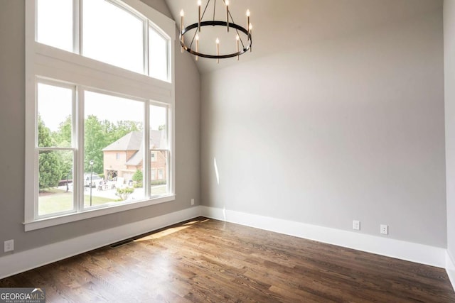 4821 Deer Creek Ct, Flowery Branch, GA 30542 - unfurnished room with a chandelier, healthy amount of natural light, wood finished floors, and vaulted ceiling