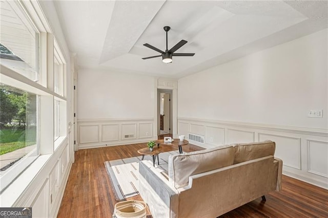 3422 Maplehurst Dr, Decatur, GA 30032 - living area with wood finished floors, wainscoting, a ceiling fan, a decorative wall, and a raised ceiling