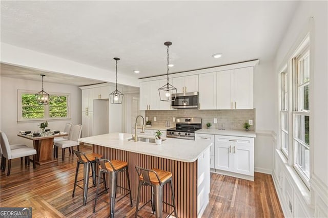 3422 Maplehurst Dr, Decatur, GA 30032 - kitchen featuring appliances with stainless steel finishes, a sink, decorative backsplash, light countertops, and white cabinetry
