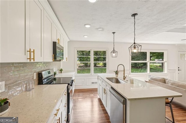 3422 Maplehurst Dr, Decatur, GA 30032 - kitchen with stainless steel appliances, a sink, dark wood-style flooring, white cabinetry, and recessed lighting
