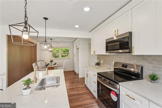 3422 Maplehurst Dr, Decatur, GA 30032 - kitchen featuring stainless steel appliances, a sink, white cabinets, dark wood-type flooring, and tasteful backsplash