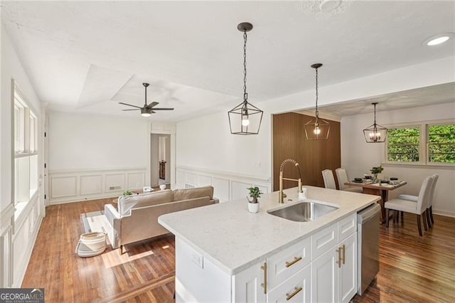 3422 Maplehurst Dr, Decatur, GA 30032 - kitchen featuring a sink, stainless steel dishwasher, a decorative wall, white cabinetry, and wainscoting