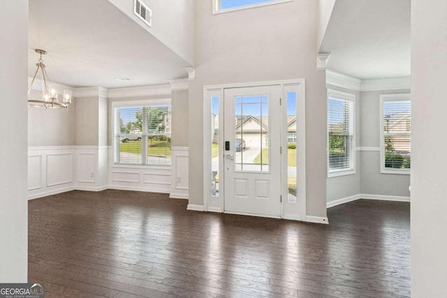 4650 Orchard View Way, Cumming, GA 30028 - foyer with hardwood / wood-style floors, plenty of natural light, ornamental molding, a chandelier, and a wainscoted wall