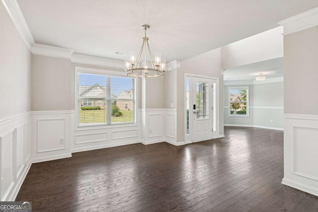 4650 Orchard View Way, Cumming, GA 30028 - unfurnished dining area featuring a chandelier, dark wood-type flooring, a decorative wall, a wainscoted wall, and ornamental molding