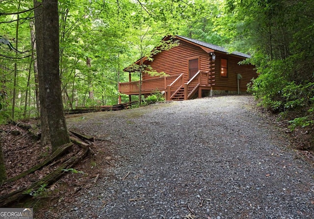58 Hatchet Trl, Cherry Log, GA 30522 - view of front of home featuring a wooded view, log exterior, and a wooden deck