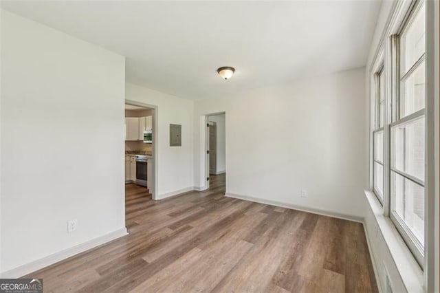 1261 Cliffwood Dr SE, Smyrna, GA 30080 - empty room featuring electric panel, baseboards, and wood finished floors