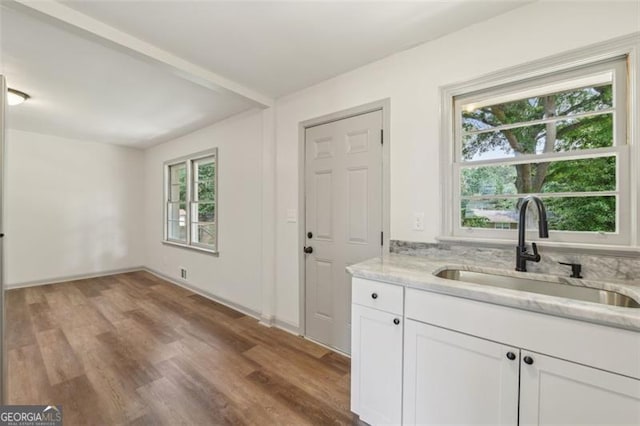 1261 Cliffwood Dr SE, Smyrna, GA 30080 - kitchen with a sink, plenty of natural light, light stone countertops, and white cabinetry