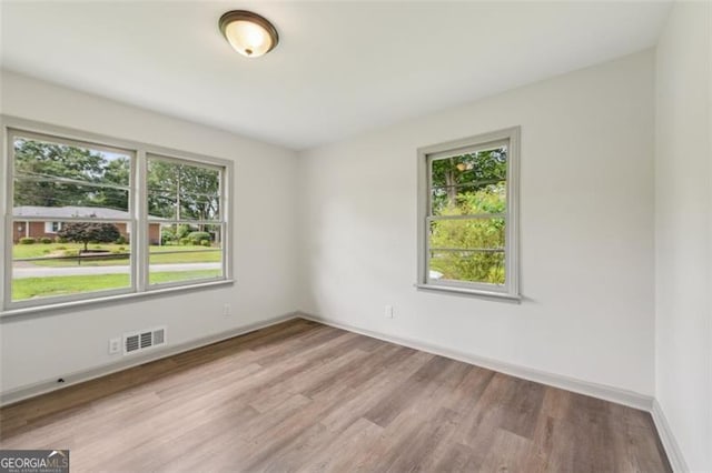 1261 Cliffwood Dr SE, Smyrna, GA 30080 - empty room featuring wood finished floors, plenty of natural light, and baseboards