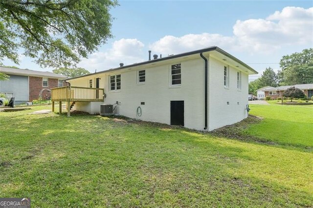 1261 Cliffwood Dr SE, Smyrna, GA 30080 - rear view of house featuring a lawn, central AC, and a deck