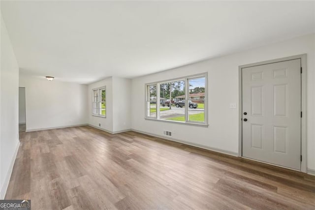 1261 Cliffwood Dr SE, Smyrna, GA 30080 - unfurnished living room featuring light wood-style flooring and baseboards