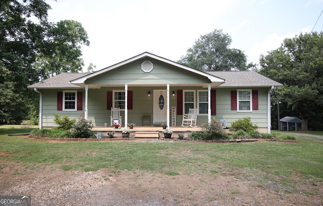 12730 Old Federal Rd, Carnesville, GA 30521 - ranch-style house with covered porch, a front lawn, and a shingled roof