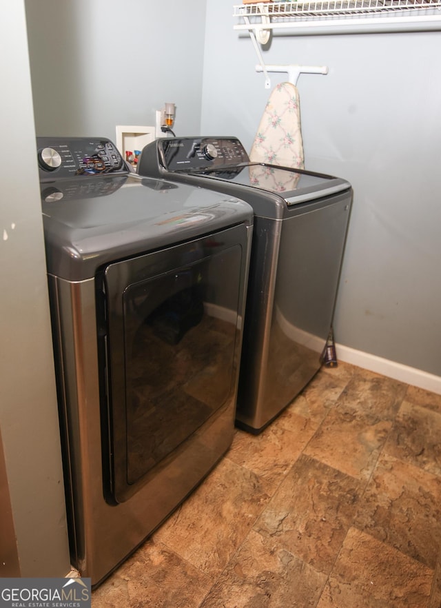 12730 Old Federal Rd, Carnesville, GA 30521 - laundry room with separate washer and dryer, stone tile flooring, and baseboards