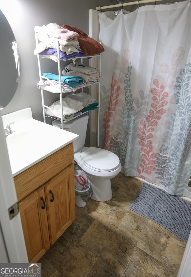 12730 Old Federal Rd, Carnesville, GA 30521 - full bath with stone tile floors, vanity, toilet, and a shower with shower curtain