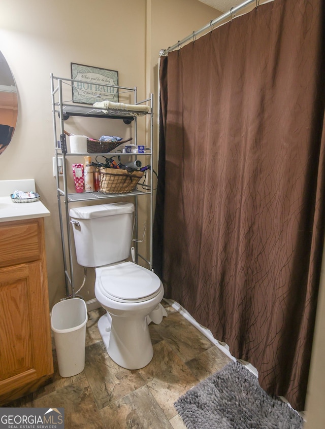 12730 Old Federal Rd, Carnesville, GA 30521 - bathroom with toilet, vanity, stone finish floors, and curtained shower