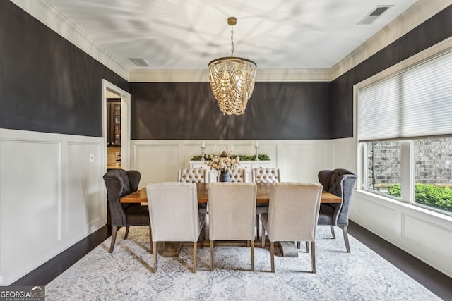 2579 Lulworth Ln, Marietta, GA 30062 - dining space featuring a decorative wall, a chandelier, wainscoting, and wood finished floors
