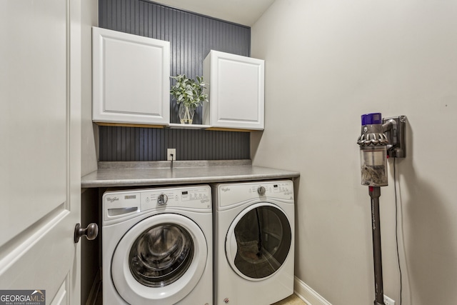 2579 Lulworth Ln, Marietta, GA 30062 - laundry area featuring cabinet space, washer and clothes dryer, and baseboards