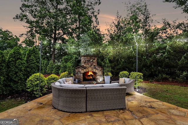 2579 Lulworth Ln, Marietta, GA 30062 - patio terrace at dusk featuring a patio and an outdoor living space with a fireplace