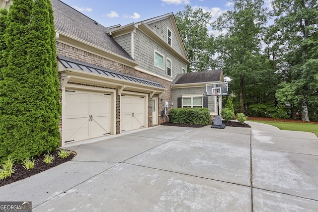 2579 Lulworth Ln, Marietta, GA 30062 - view of front of home with driveway, a shingled roof, and a standing seam roof