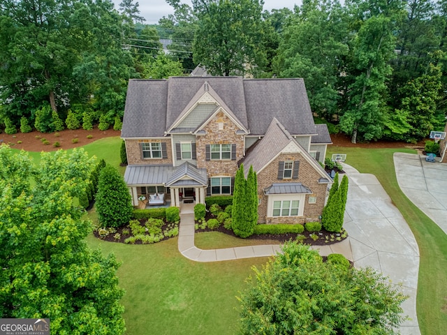 2579 Lulworth Ln, Marietta, GA 30062 - craftsman house featuring a standing seam roof, stone siding, a front lawn, and metal roof