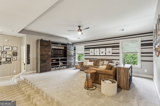 2579 Lulworth Ln, Marietta, GA 30062 - carpeted living room with a barn door, baseboards, and ceiling fan