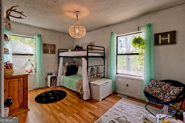 41 Mike Foster Ln, Clayton, GA 30525 - bedroom with a textured ceiling and light wood finished floors