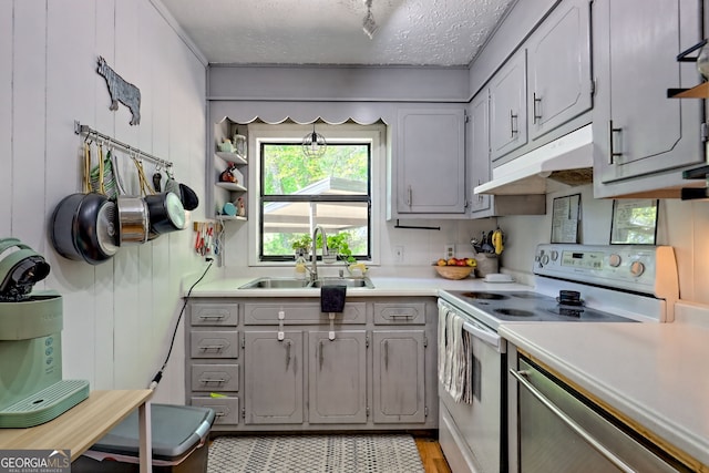 41 Mike Foster Ln, Clayton, GA 30525 - kitchen with a sink, white range with electric cooktop, under cabinet range hood, gray cabinets, and light countertops