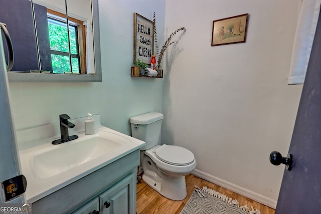 41 Mike Foster Ln, Clayton, GA 30525 - bathroom featuring vanity, wood finished floors, toilet, and baseboards