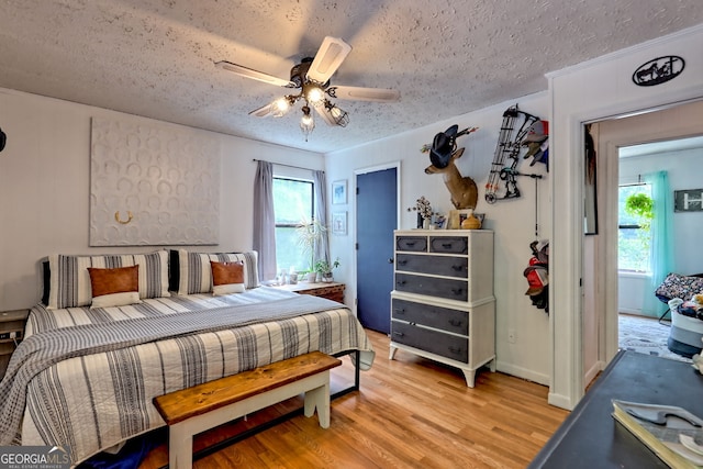 41 Mike Foster Ln, Clayton, GA 30525 - bedroom featuring a textured ceiling, light wood-style floors, and a ceiling fan