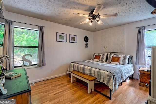 41 Mike Foster Ln, Clayton, GA 30525 - bedroom featuring light wood-style flooring, baseboards, a textured ceiling, and ceiling fan