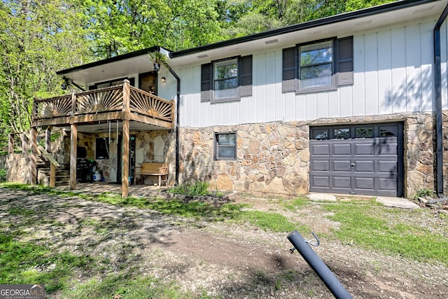 41 Mike Foster Ln, Clayton, GA 30525 - rear view of property with stone siding, a deck, a garage, and stairway