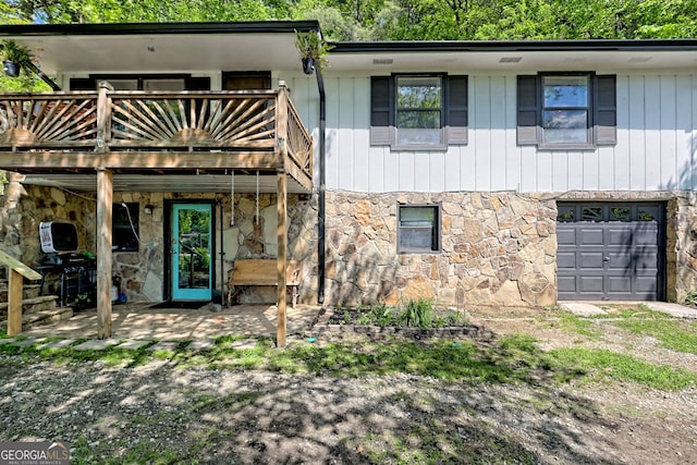 41 Mike Foster Ln, Clayton, GA 30525 - view of front of home featuring stone siding, a garage, and a wooden deck