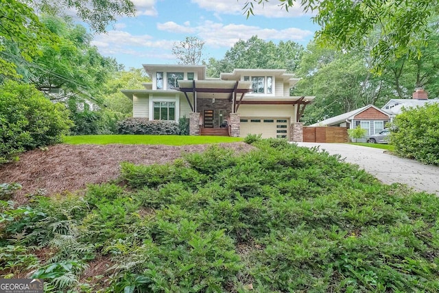 1267 Thomas Rd, Decatur, GA 30030 - view of front facade featuring stone siding, driveway, and an attached garage