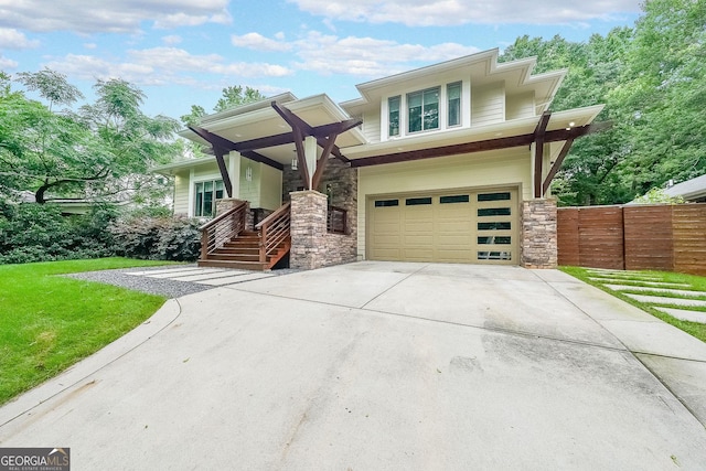 1267 Thomas Rd, Decatur, GA 30030 - view of front of house featuring stone siding, an attached garage, and driveway