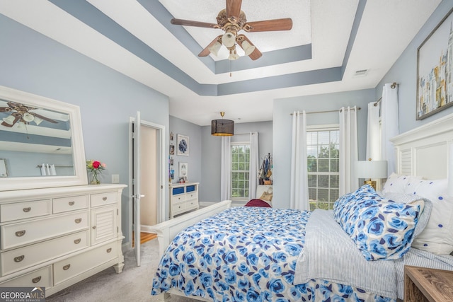 158 Sugarloaf Cir, Macon, GA 31204 - bedroom featuring a tray ceiling, light carpet, and ceiling fan