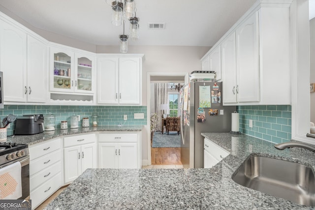 158 Sugarloaf Cir, Macon, GA 31204 - kitchen featuring a sink, white cabinets, stone counters, and glass insert cabinets