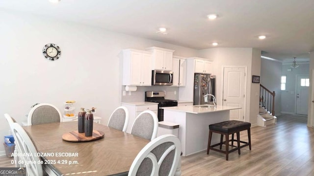 2757 Malton Way, Loganville, GA 30052 - dining space with stairs, light wood-type flooring, and recessed lighting