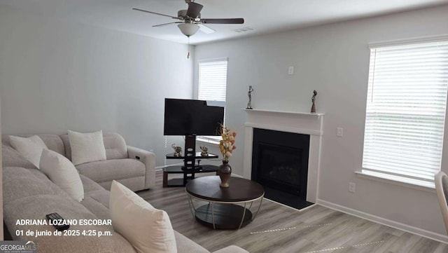 2757 Malton Way, Loganville, GA 30052 - living room featuring ceiling fan, wood finished floors, and a fireplace