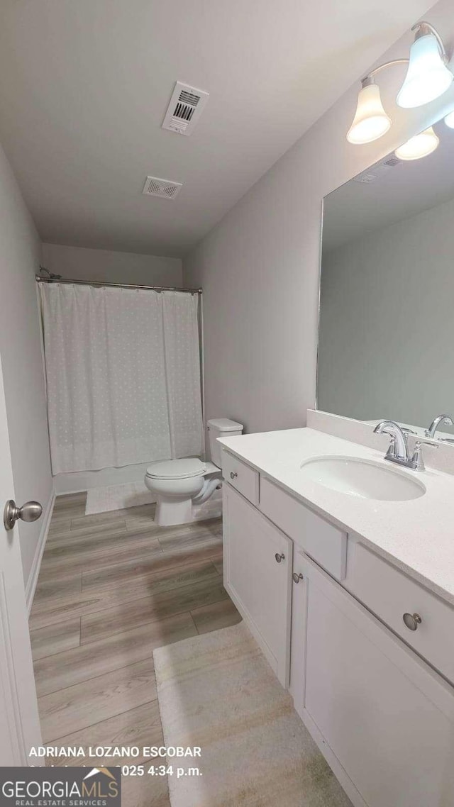 2757 Malton Way, Loganville, GA 30052 - full bathroom featuring vanity, wood finished floors, and a shower with curtain