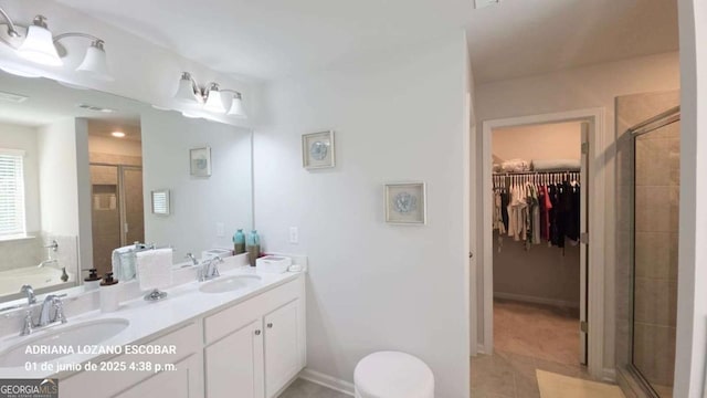 2757 Malton Way, Loganville, GA 30052 - bathroom with a shower stall, double vanity, a walk in closet, and a bath