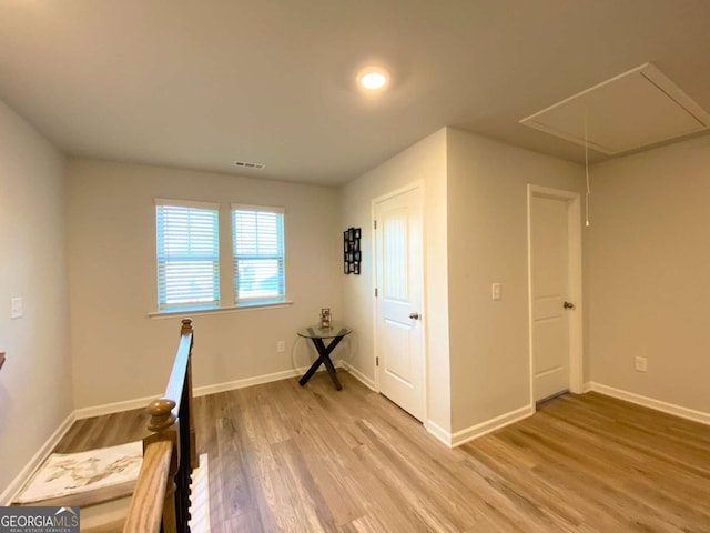 2757 Malton Way, Loganville, GA 30052 - unfurnished bedroom featuring attic access and light wood finished floors