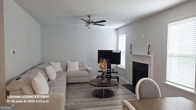 2757 Malton Way, Loganville, GA 30052 - living room featuring a ceiling fan, wood finished floors, and a fireplace