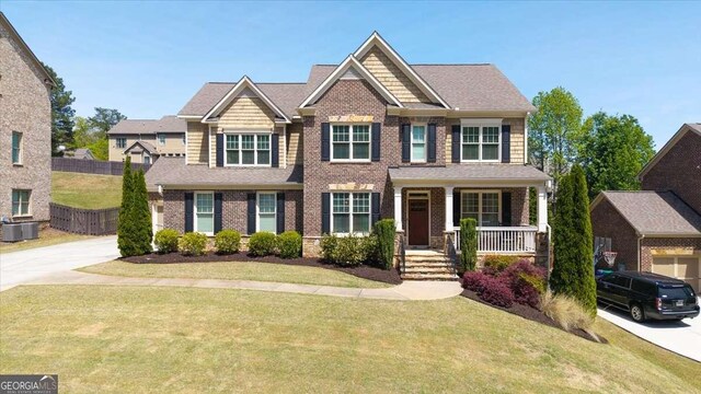 622 Rocky Creek Pt, Woodstock, GA 30188 - craftsman house with a porch, brick siding, concrete driveway, and central air condition unit