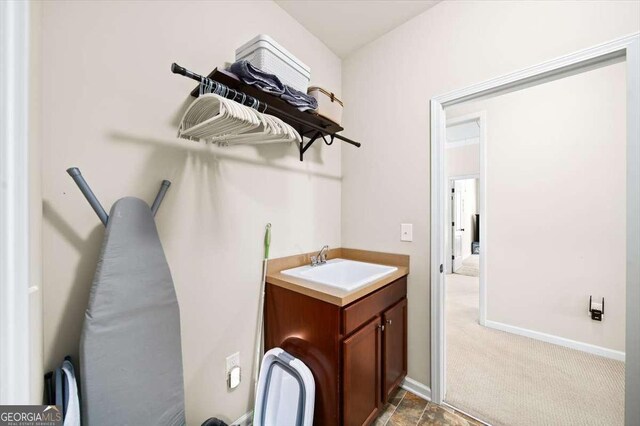 622 Rocky Creek Pt, Woodstock, GA 30188 - laundry area with cabinet space, baseboards, and light colored carpet