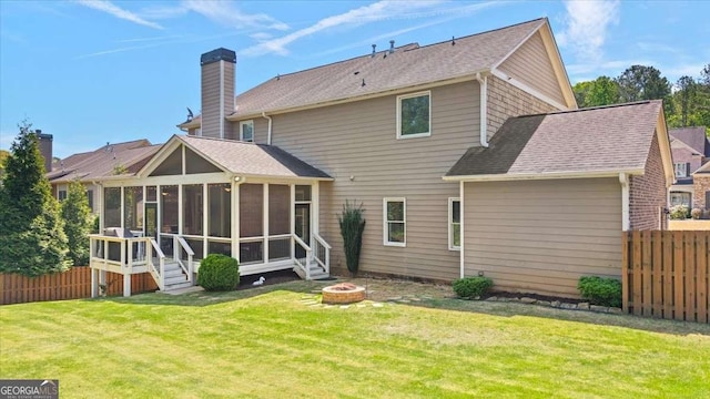622 Rocky Creek Pt, Woodstock, GA 30188 - back of house with an outdoor fire pit, a sunroom, a chimney, and a shingled roof