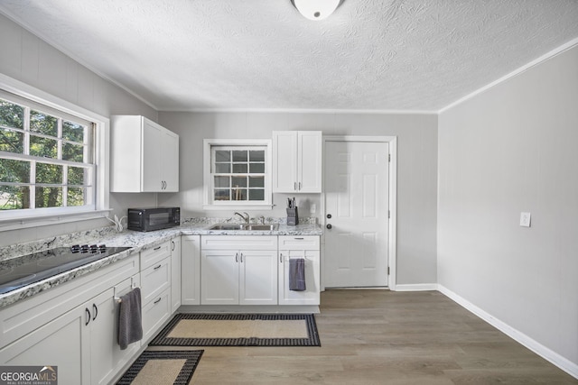 20 Willingham St SW, Rome, GA 30161 - kitchen with ornamental molding, black appliances, a sink, white cabinets, and light wood-style floors