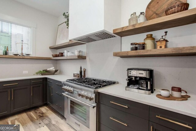 1168 Mado Loop, Chattahoochee Hills, GA 30268 - kitchen with open shelves, stainless steel stove, custom range hood, light wood-type flooring, and light countertops