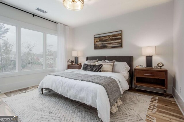 1168 Mado Loop, Chattahoochee Hills, GA 30268 - bedroom with multiple windows, wood finished floors, and baseboards