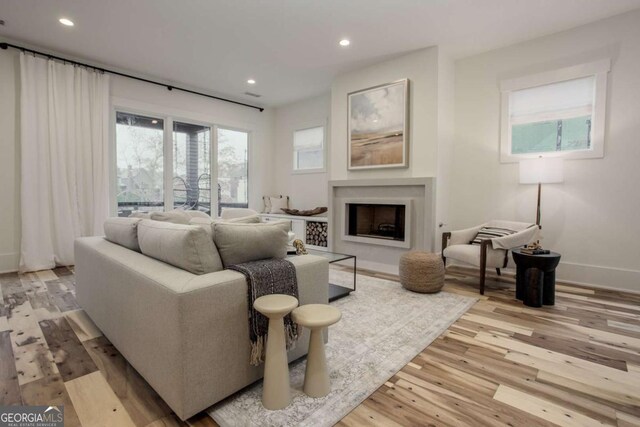 1168 Mado Loop, Chattahoochee Hills, GA 30268 - living area with light wood-type flooring, recessed lighting, a fireplace, and baseboards