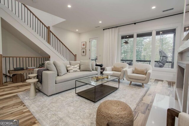 1168 Mado Loop, Chattahoochee Hills, GA 30268 - living room featuring wood finished floors, recessed lighting, and stairway